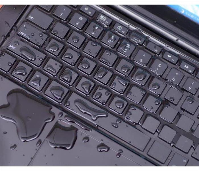 Above view of laptop with water drop damage liquid wet and spill on keyboard