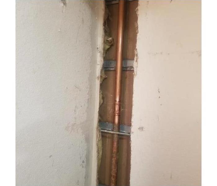Pipe. Broken pipe. Broken pipe causes water damage to a home.