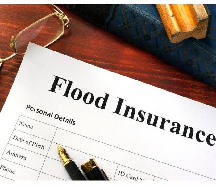 Flood Insurance Policy on an office desk