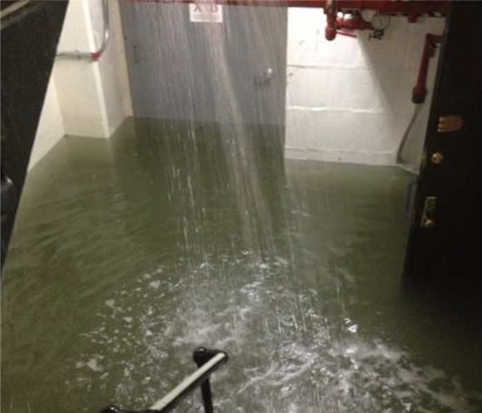 Pipe burst leaking water into a stairwell.