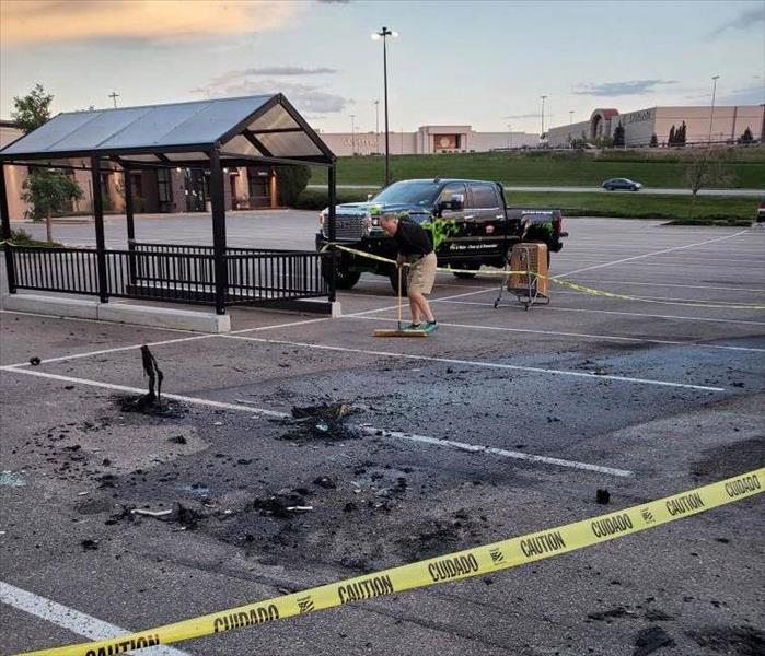 fire debris in a commercial parking lot due to a car fire